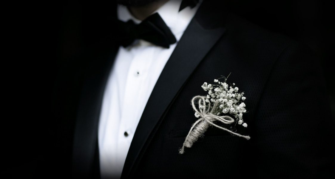Webshops mit Eindruck von arven.io Ein eleganter Smoking mit einer Ansteckblume in schwarz und weiß